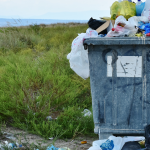 An overflowing garbage can.
